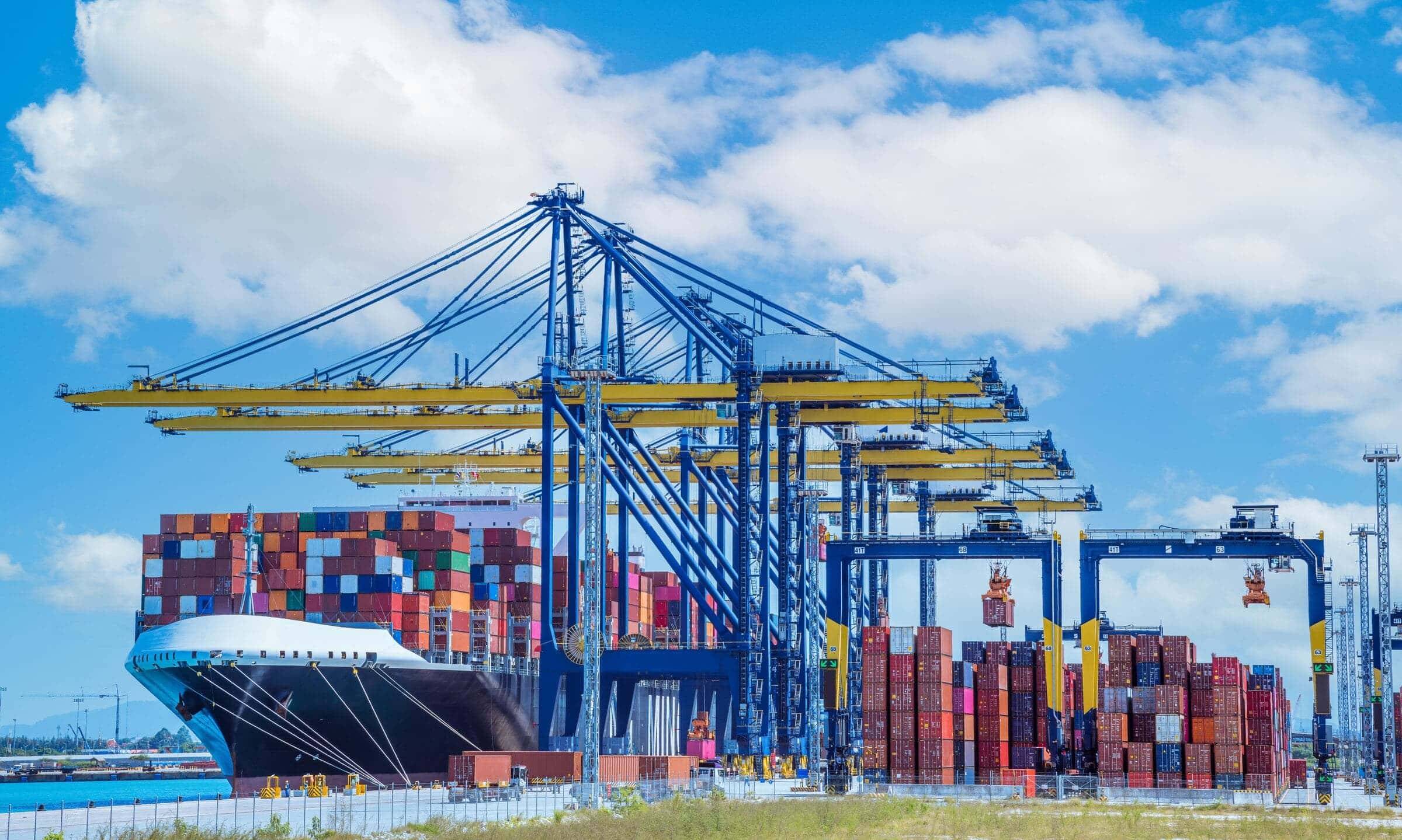 Gantry cranes loading a container ship at a port terminal